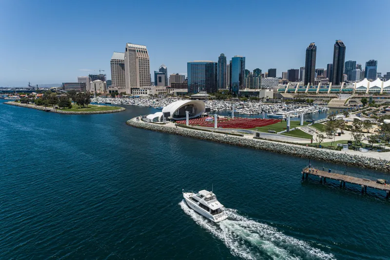 All Falked Up Yacht Photos Pics 1999 Carver 530 Voyager Pilothouse cruising near San Diego skyline and marina.