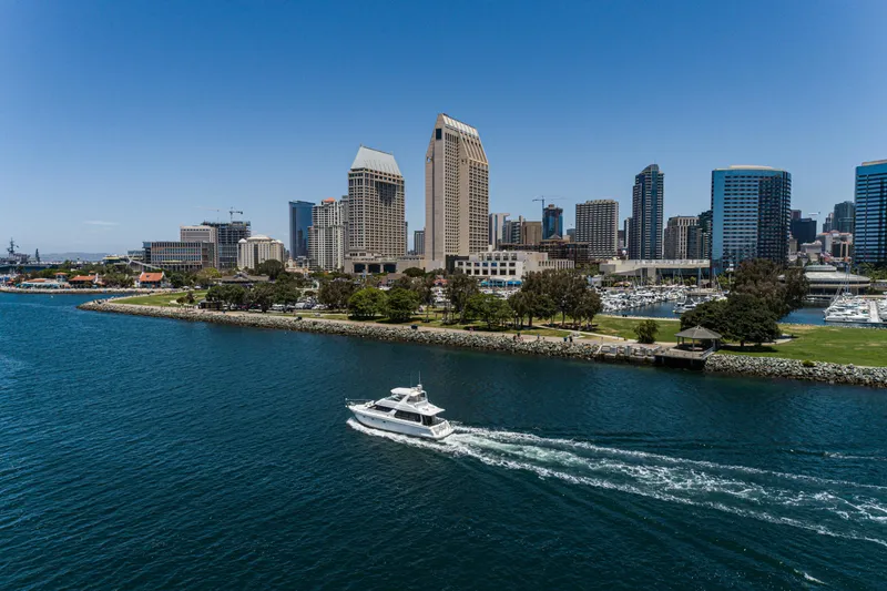 All Falked Up Yacht Photos Pics 1999 Carver 530 Voyager Pilothouse cruising near city skyline and waterfront park.