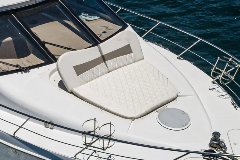 All Falked Up Yacht Photos Pics 1999 Carver 530 Voyager Pilothouse yacht with cushioned sun deck on blue water.