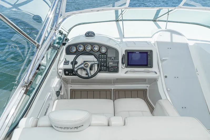 All Falked Up Yacht Photos Pics 1999 Carver 530 Voyager Pilothouse helm with steering wheel and navigation instruments.