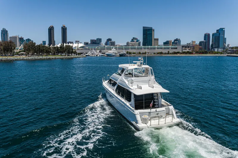 All Falked Up Yacht Photos Pics 1999 Carver 530 Voyager Pilothouse yacht cruising near city skyline.