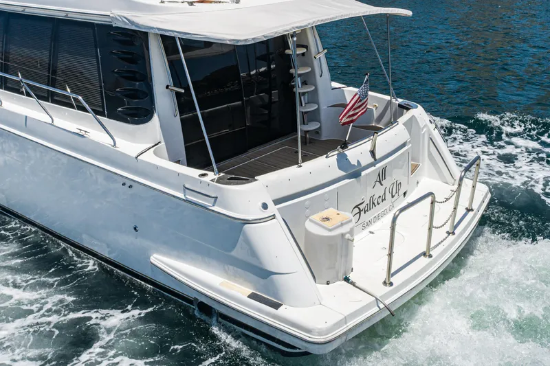 All Falked Up Yacht Photos Pics 1999 Carver 530 Voyager Pilothouse yacht cruising on water, rear view.