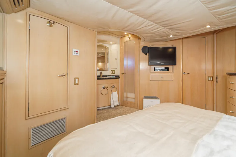 All Falked Up Yacht Photos Pics Interior of 1999 Carver 530 Voyager Pilothouse with TV, wood paneling, and bathroom.