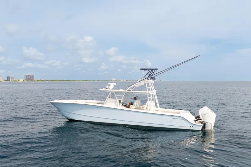 Seeking Twin Tales Yacht Photos Pics 2022 Invincible 46 Catamaran on open water, showcasing sleek design and powerful engines.