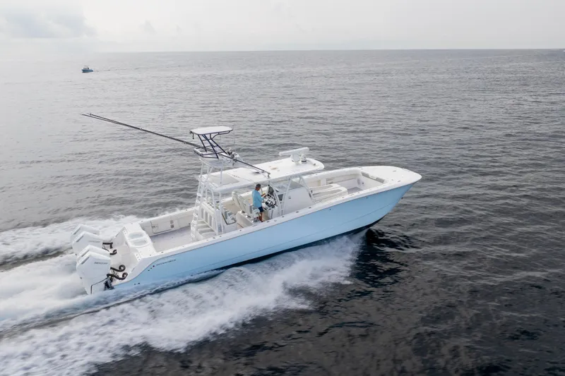 Seeking Twin Tales Yacht Photos Pics 2022 Invincible 46 Catamaran cruising on open water, showcasing sleek design and powerful engines.