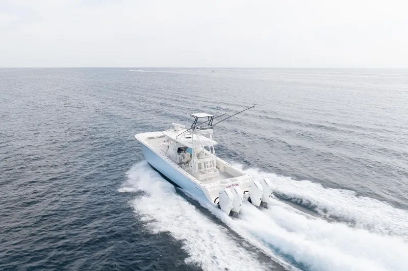 Seeking Twin Tales Yacht Photos Pics 2022 Invincible 46 Catamaran cruising on open sea, showcasing powerful engines and sleek design.