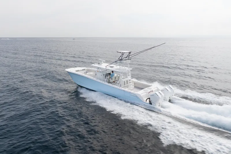 Seeking Twin Tales Yacht Photos Pics 2022 Invincible 46 Catamaran cruising on open water, showcasing sleek design and powerful engines.