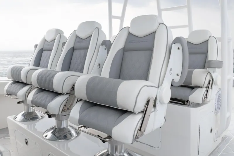 Seeking Twin Tales Yacht Photos Pics Luxurious seating on 2022 Invincible 46 Catamaran, featuring plush gray and white upholstery.