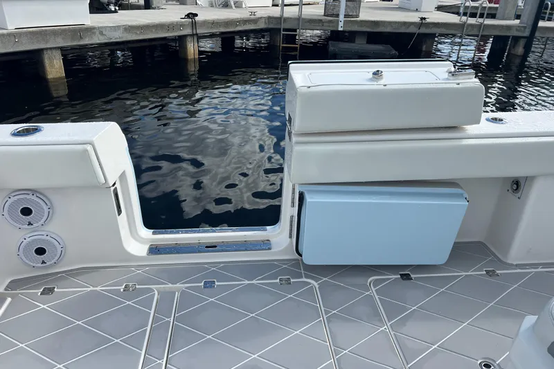 Seeking Twin Tales Yacht Photos Pics 2022 Invincible 46 Catamaran deck with speakers and storage, dockside view.