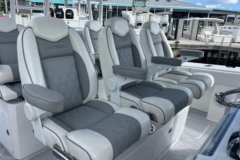 Seeking Twin Tales Yacht Photos Pics Luxurious seating on 2022 Invincible 46 Catamaran, featuring plush gray and white upholstery.