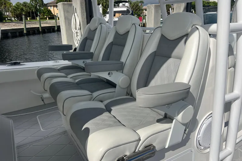 Seeking Twin Tales Yacht Photos Pics Luxury seating on 2022 Invincible 46 Catamaran, featuring plush, ergonomic design.