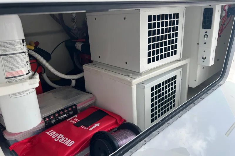 Seeking Twin Tales Yacht Photos Pics Storage compartment of 2022 Invincible 46 Catamaran with equipment and safety gear.