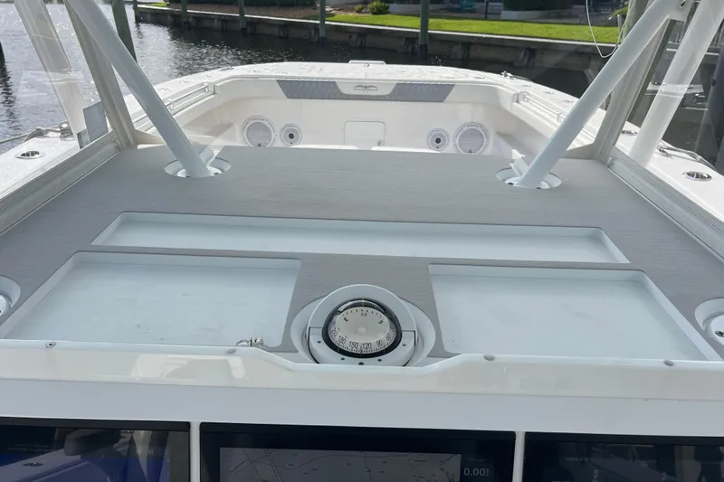 Seeking Twin Tales Yacht Photos Pics 2022 Invincible 46 Catamaran helm with compass and navigation equipment.