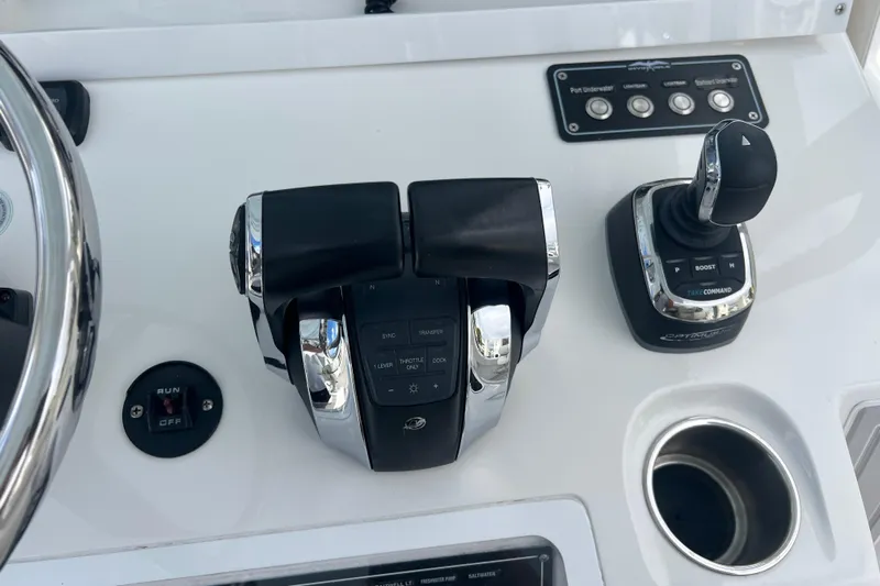 Seeking Twin Tales Yacht Photos Pics Control panel of 2022 Invincible 46 Catamaran with throttle and joystick controls.