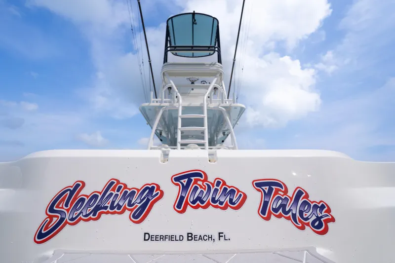 Seeking Twin Tales Yacht Photos Pics Invincible 46 Catamaran 2022, "Seeking Twin Tales," Deerfield Beach, FL, under blue sky.