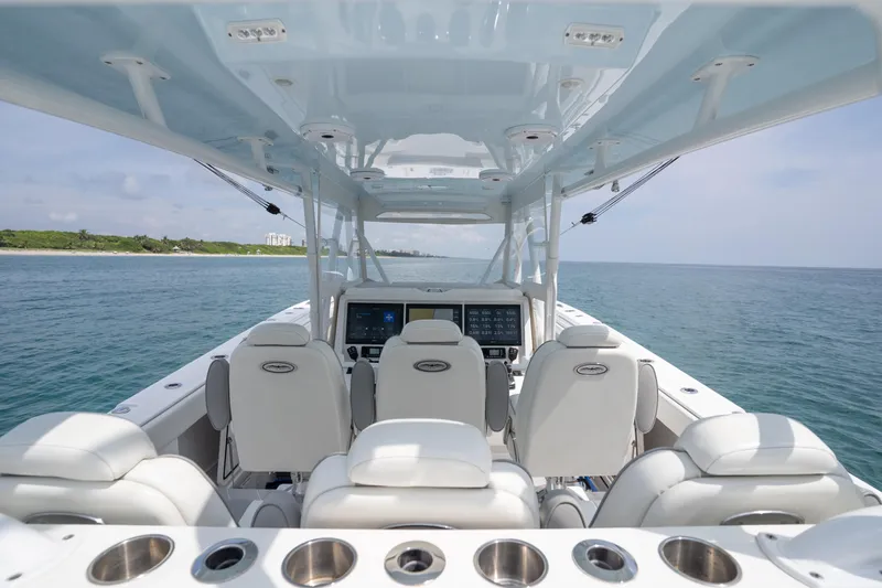 Seeking Twin Tales Yacht Photos Pics 2022 Invincible 46 Catamaran interior with ocean view, featuring modern seating and navigation controls.