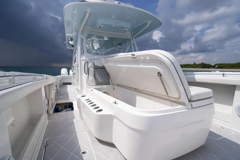 Seeking Twin Tales Yacht Photos Pics 2022 Invincible 46 Catamaran with open storage, sleek design, and ocean backdrop.