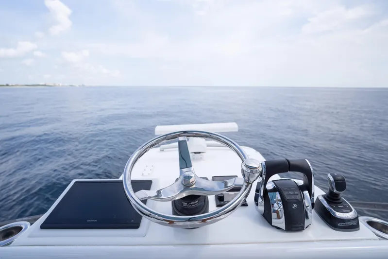 Seeking Twin Tales Yacht Photos Pics Helm of 2022 Invincible 46 Catamaran with ocean view, featuring modern controls and steering.