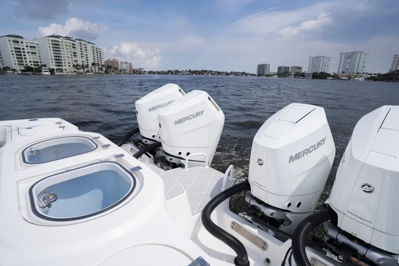 Seeking Twin Tales Yacht Photos Pics Invincible 46 Catamaran 2022 with Mercury engines on a scenic waterfront.