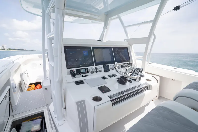 Seeking Twin Tales Yacht Photos Pics 2022 Invincible 46 Catamaran cockpit with advanced navigation systems and steering wheel.