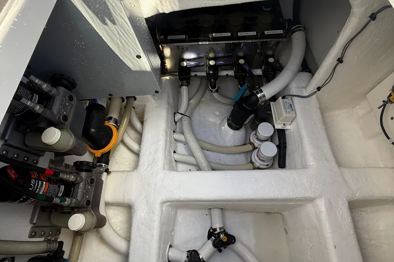 Seeking Twin Tales Yacht Photos Pics Engine room of 2022 Invincible 46 Catamaran with visible pipes and components.