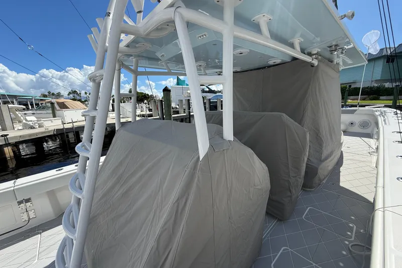 Seeking Twin Tales Yacht Photos Pics 2022 Invincible 46 Catamaran with covered seating, docked under a clear sky.
