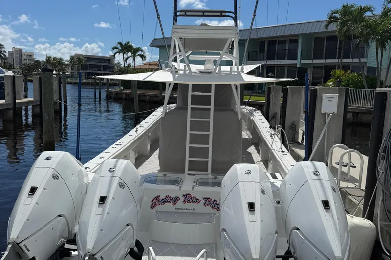 Seeking Twin Tales Yacht Photos Pics 2022 Invincible 46 Catamaran docked, featuring four powerful outboard engines.