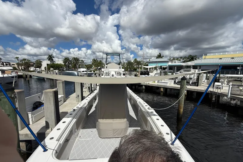 Seeking Twin Tales Yacht Photos Pics 2022 Invincible 46 Catamaran docked at marina under cloudy sky.