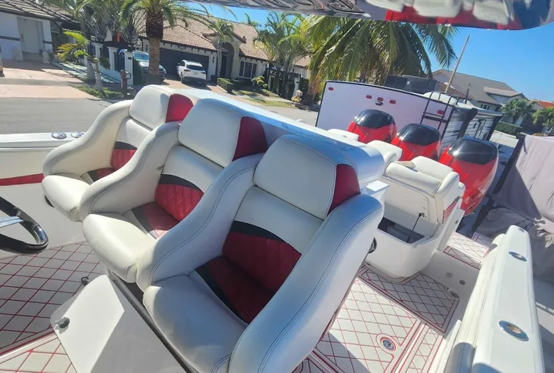  Yacht Photos Pics 2012 Deep Impact 36 Cuddy Cabin with luxurious seating and powerful engines, docked in a sunny location.