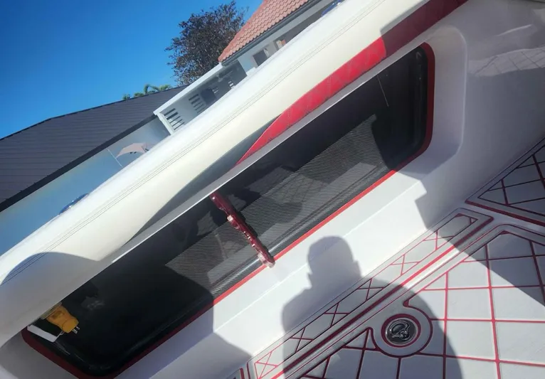  Yacht Photos Pics 2012 Deep Impact 36 Cuddy Cabin interior with red accents and geometric floor design.