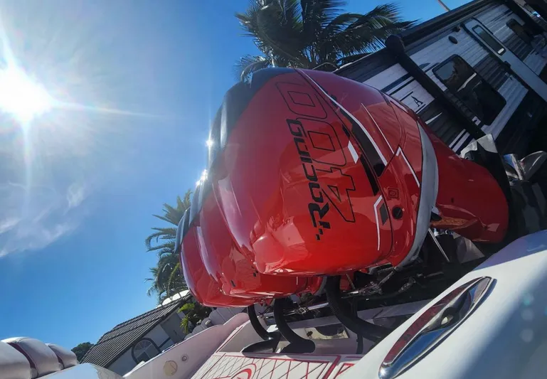  Yacht Photos Pics Red outboard engines on a 2012 Deep Impact 36 Cuddy Cabin boat under a sunny sky.