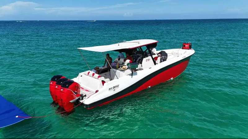  Yacht Photos Pics 2012 Deep Impact 36 Cuddy Cabin boat on clear turquoise water.