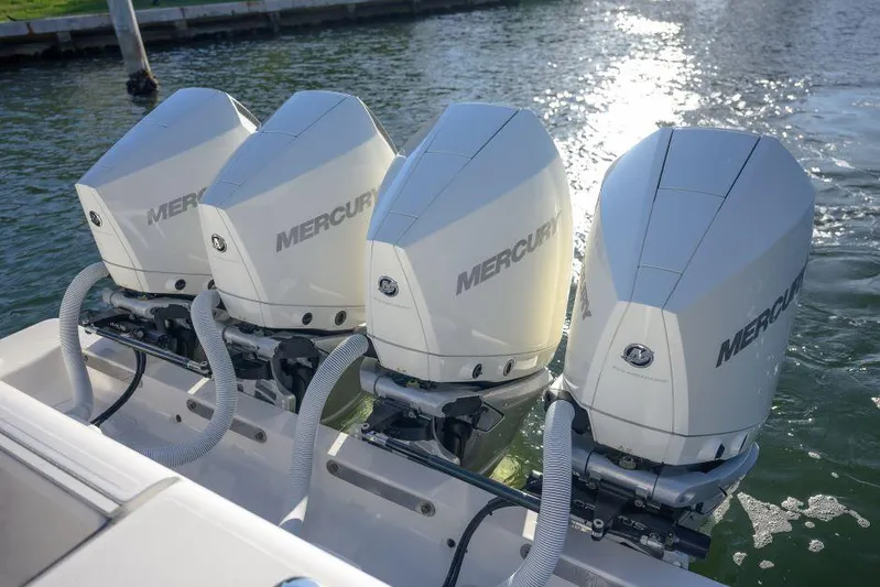  Yacht Photos Pics Triple Mercury outboard engines on a 2022 SeaVee 390Z boat, docked by the water.