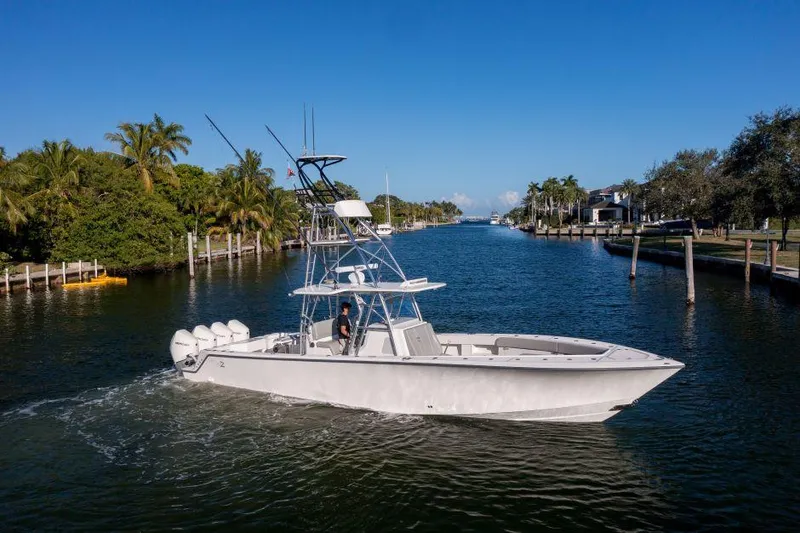  Yacht Photos Pics 2022 SeaVee 390Z boat cruising on a scenic waterway with palm trees.