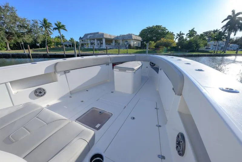  Yacht Photos Pics 2022 SeaVee 390Z boat interior with seating, docked near waterfront homes.