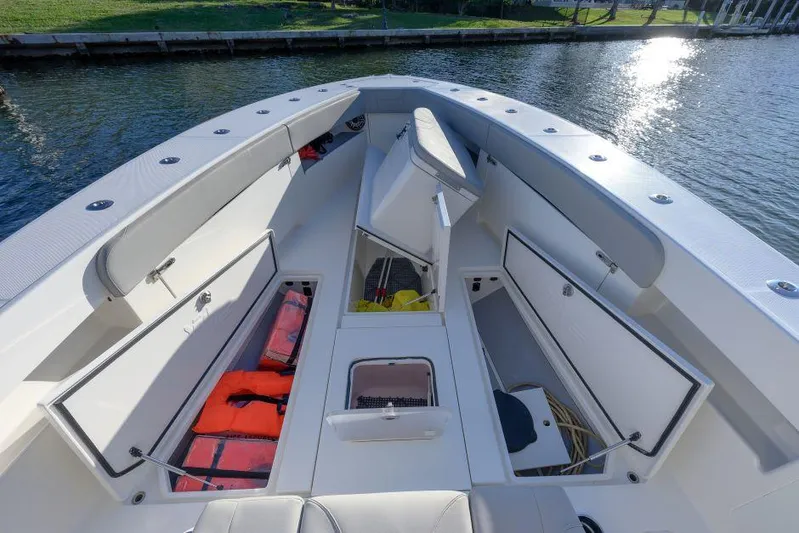  Yacht Photos Pics 2022 SeaVee 390Z boat interior with open storage compartments and life jackets.