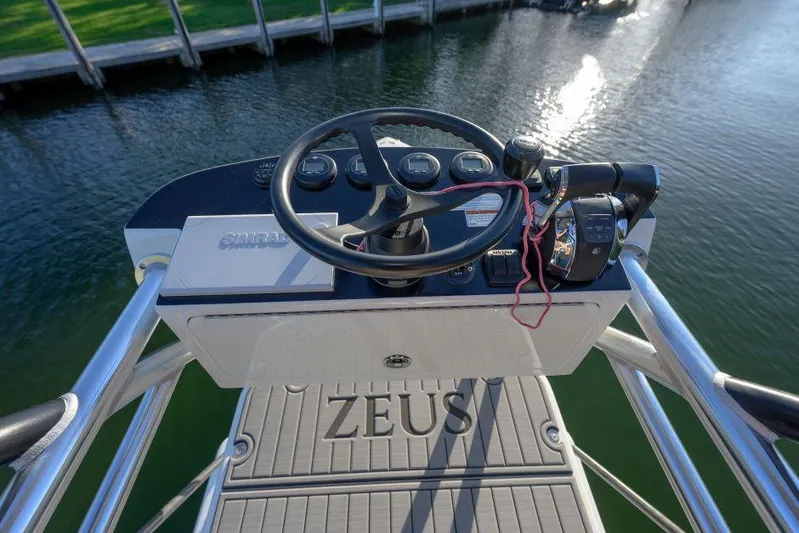  Yacht Photos Pics 2022 SeaVee 390Z boat helm with steering wheel and controls, dockside view.