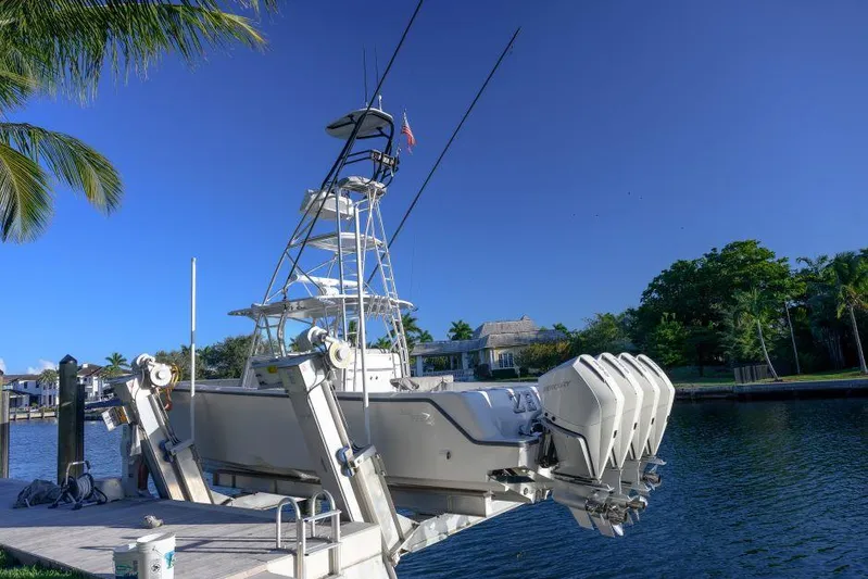  Yacht Photos Pics 2022 SeaVee 390Z boat docked, featuring multiple outboard engines, under a clear blue sky.