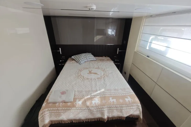 Arktur Yacht Photos Pics Luxurious bedroom interior of 2023 Cranchi Sessantasette 67 yacht with elegant bedding.