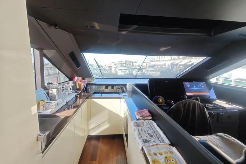 Arktur Yacht Photos Pics Luxurious interior of 2023 Cranchi Sessantasette 67 yacht with modern helm and kitchen area.