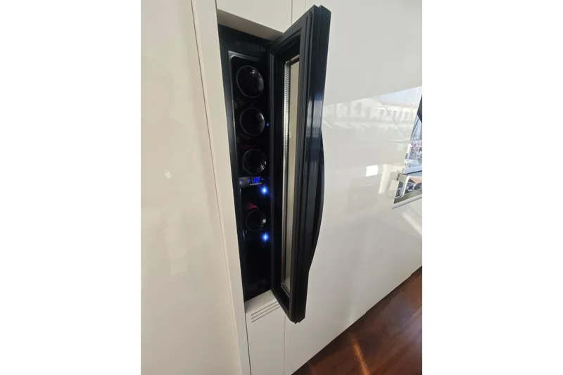 Arktur Yacht Photos Pics Wine cooler in 2023 Cranchi Sessantasette 67 yacht interior, showcasing sleek design and functionality.