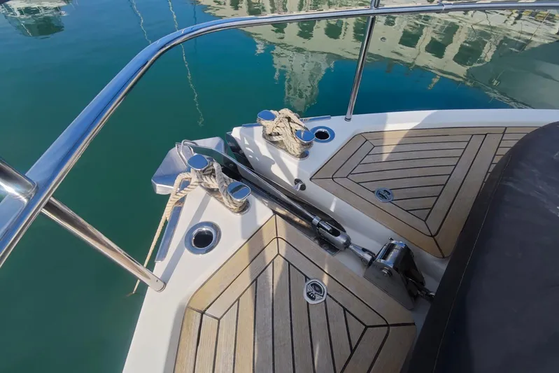Arktur Yacht Photos Pics 2023 Cranchi Sessantasette 67 yacht deck with teak flooring and stainless steel fittings.