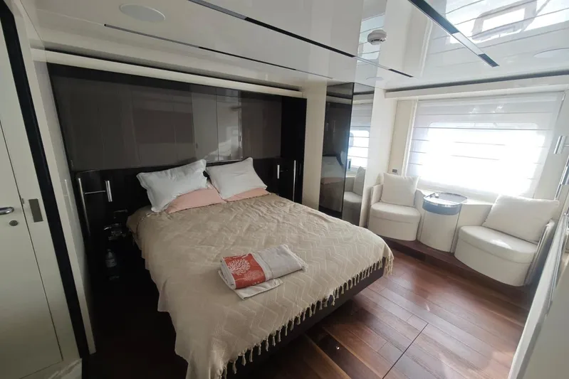 Arktur Yacht Photos Pics Luxurious bedroom interior of 2023 Cranchi Sessantasette 67 yacht with elegant furnishings.