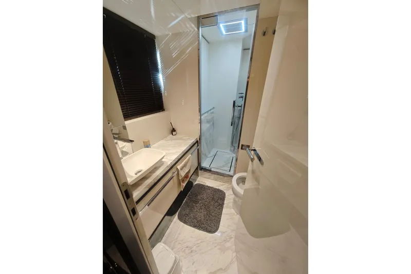 Arktur Yacht Photos Pics Luxurious bathroom in 2023 Cranchi Sessantasette 67 yacht with modern fixtures and marble accents.