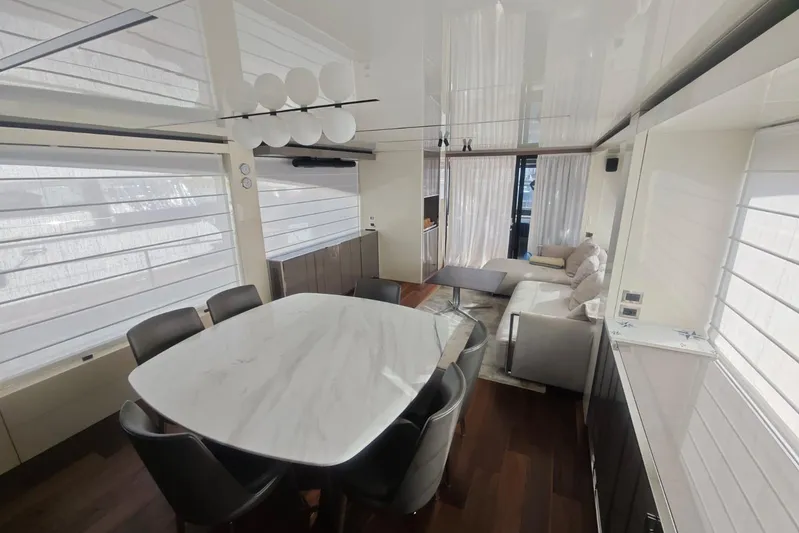 Arktur Yacht Photos Pics Luxurious interior of 2023 Cranchi Sessantasette 67 yacht with modern dining and living area.