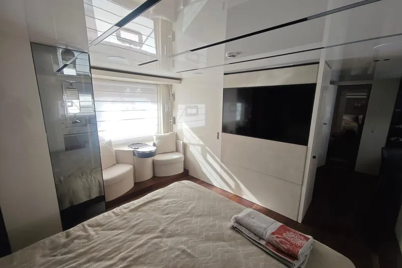 Arktur Yacht Photos Pics Luxurious interior of 2023 Cranchi Sessantasette 67 yacht with modern furnishings and large window.