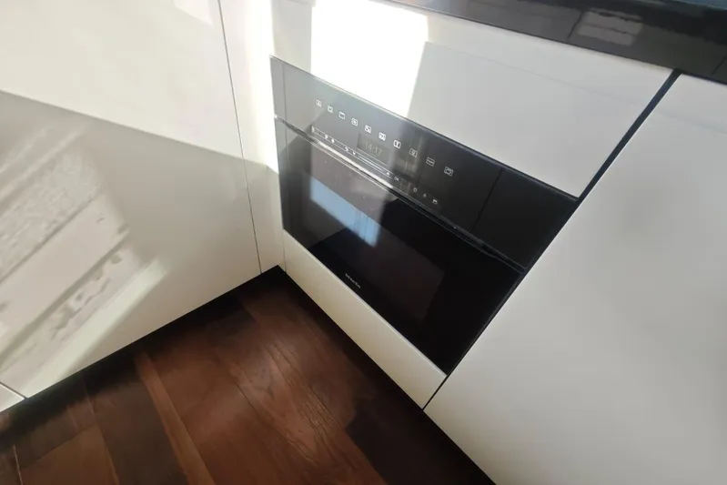 Arktur Yacht Photos Pics Modern kitchen appliance in Cranchi Sessantasette 67 yacht, 2023 model, with sleek design.