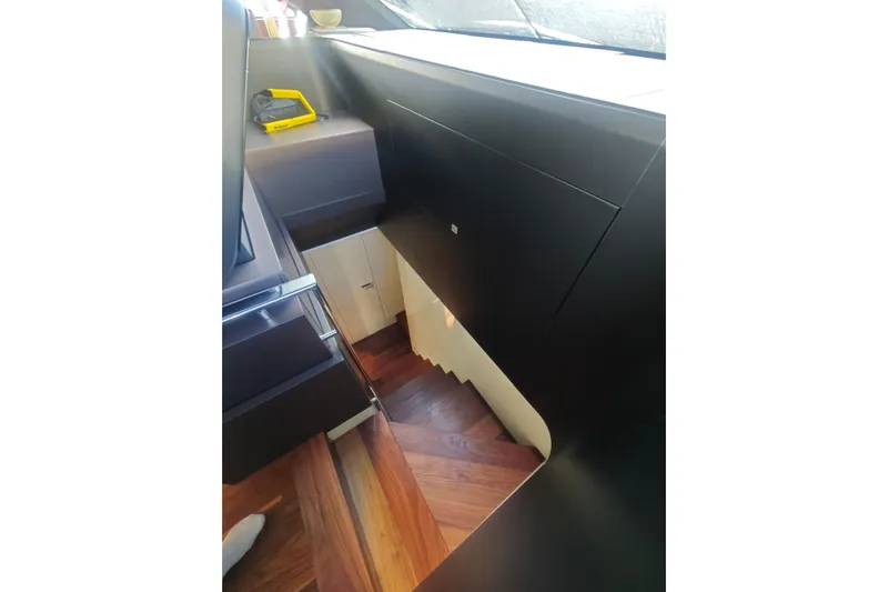 Arktur Yacht Photos Pics Interior staircase of 2023 Cranchi Sessantasette 67 yacht with sleek wooden design.