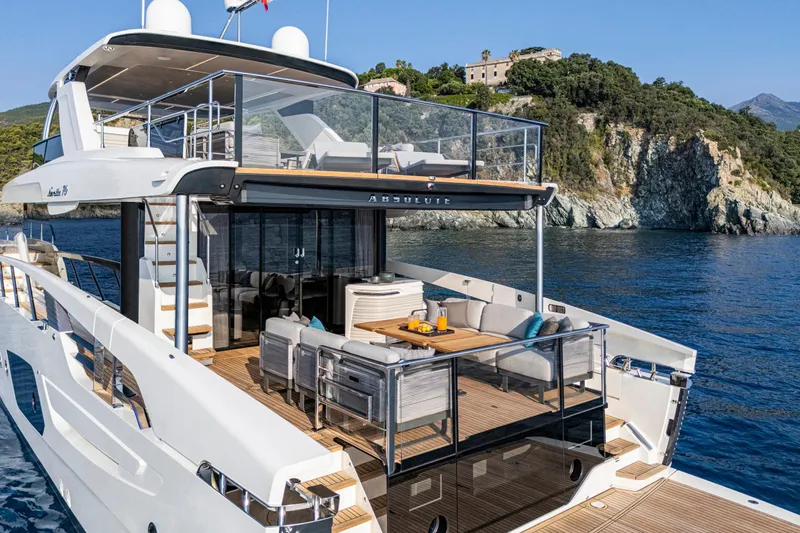  Yacht Photos Pics Luxurious Absolute NAVETTA 70 yacht cruising near scenic cliffs, 2026 model.