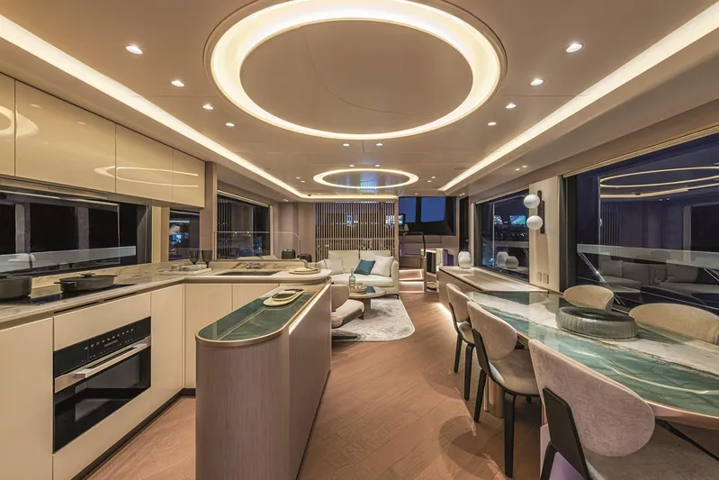  Yacht Photos Pics Luxurious interior of 2026 Absolute NAVETTA 70 yacht with modern kitchen and elegant dining area.